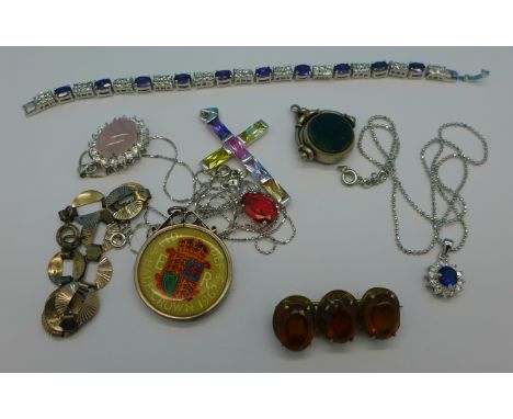 A Victorian silver swivel fob, a silver cross pendant, a silver mounted coin, etc.