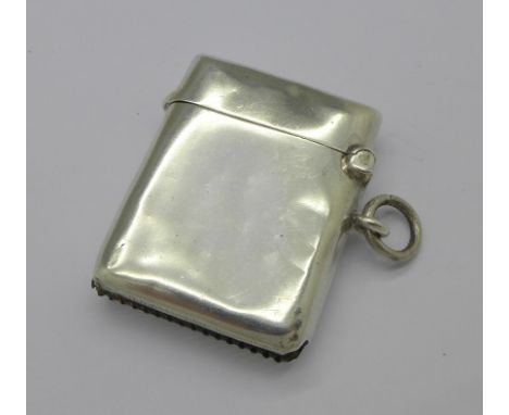 A silver vesta case