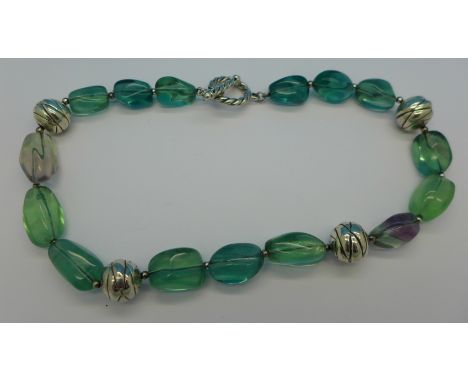 A silver and green stone necklace