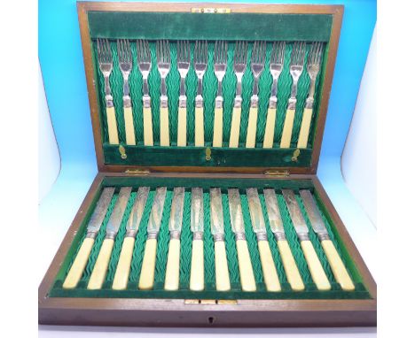 A cased set of knives and forks with silver ferrules, hallmarked Sheffield 1906