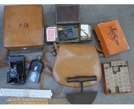 A leather bag, a box, a camera, rulers, hip flask, etc.