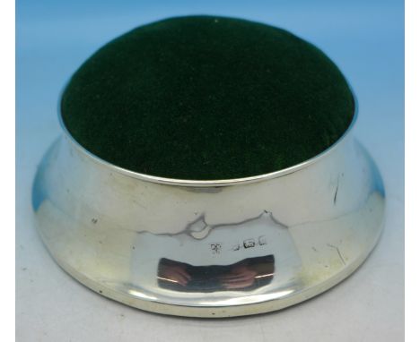 A silver pin cushion