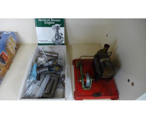 A Mamod steam engine on static base and a vertical steam engine in parts to be built
