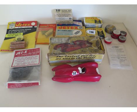A Jetex jet propelled racing car with original box, three Jetex 50 10 solid fuel pellets, a tin of 20 Jetex solid fuel charge