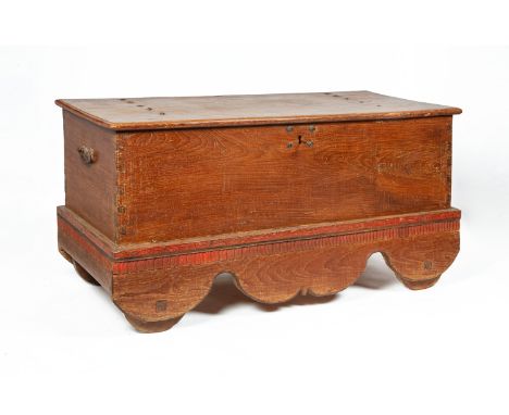 A VERY LARGE INDONESIAN TEAK WHEELED TRUNK
The hinged cover with original wrought hinges and central lock, the underside of c