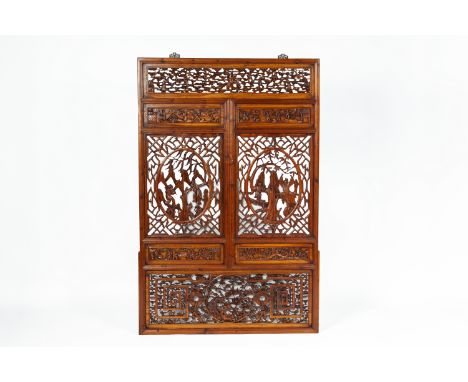 A CARVED WOOD WALL PANEL
With open fretwork and carved panelled decoration of figures in landscapes, birds amongst foliage, b