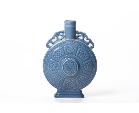 A CHINESE MONOCHROME PORCELAIN MOON FLASK
With a raised central medallion and stylised fish and floral decoration, the neck f