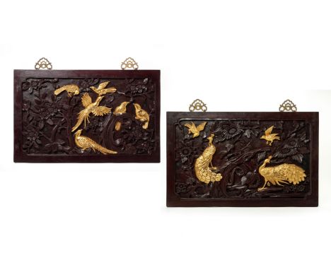 A PAIR OF CHINESE CARVED WOOD PANELS
Decorated with carved gilded birds and peacocks amongst flowering foliage in relief
42.5