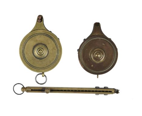 A brass rotary percussion cap applicator (capper), round body with screw-off cover, spring loaded feed mechanism; another sim