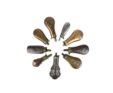 A collection of small powder flasks, including: a nickel silver flask of pistol or revolver size, bag-shaped body, decorative