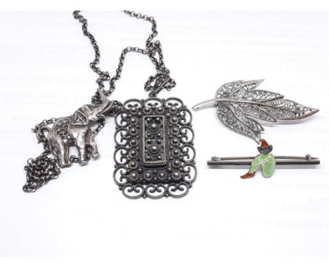 A Scandinavian filigree and hammered pendant marked '925S', 48mm x 34mm, on 60cm chain unmarked, together with an elephant br