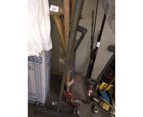 A bundle of garden tools, spade, fork, rake and a Moveit tool. 