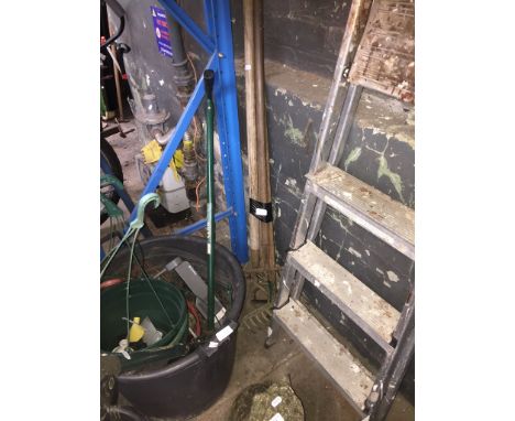 An assortment of garden tools, ladder, etc. 