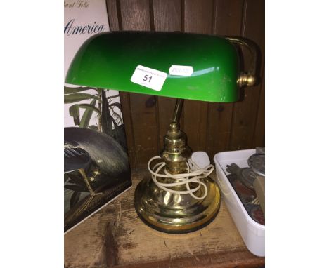 A brass desk lamp 