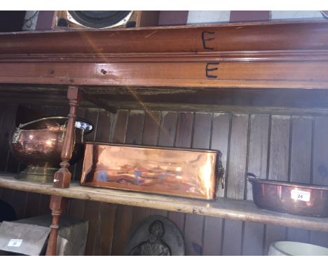 A copper pot with brass handles, a copper planter with brass lion's heads handles and a copper and brass coal scuttle with ce