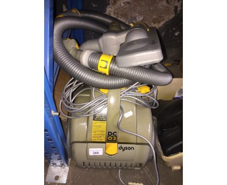 A Dyson DC02 vacuum cleaner with tools. 