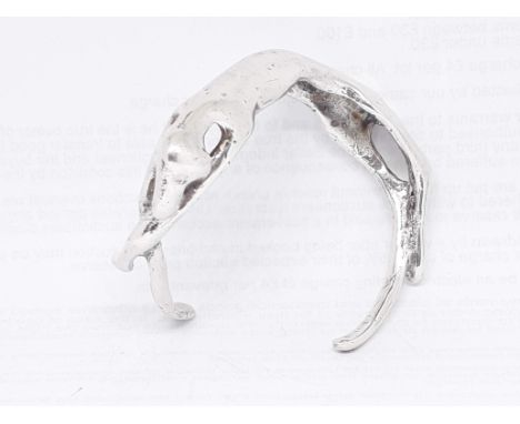 A modern silver bangle formed as a stylised sleeping dog, spnsor's mark 'JPT', London 1978, wt. 78.14g (2 1/2oz), diam. appro