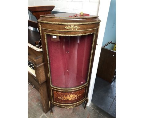 A reproduction continental glazed corner display cabinet with marquetry inlaid panel and gilt metal mounts.Condition:- has on