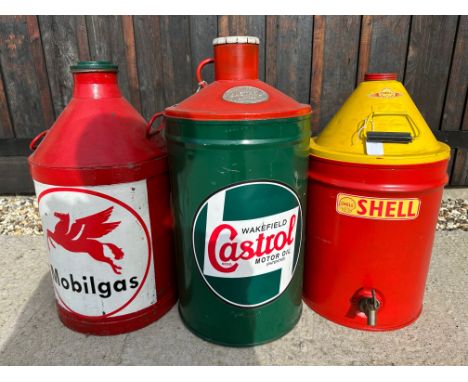 Three large oil drums decorated with Castrol, Mobilgas and Shell livery.