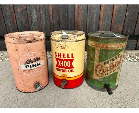 Three five gallon oil drums: Wakefield Castrol, Shell X-100 and Aladdin Pink.