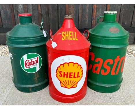 Three large oil drums decorated with Castrol and Shell livery. 