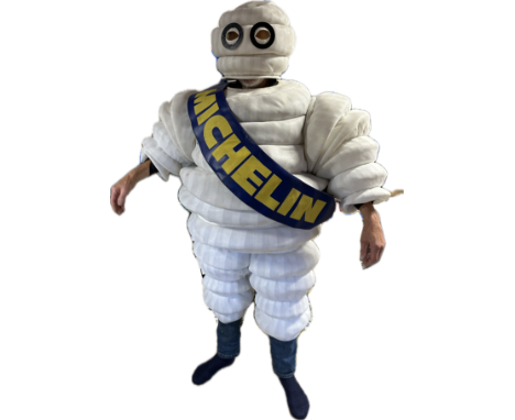 A Mr. Bibendum promotional suit comprising a body, head, arms, legs, boots, sash and large vinyl transportation bag. See imag