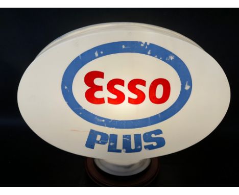 An Esso Plus plastic petrol pump globe, faded.