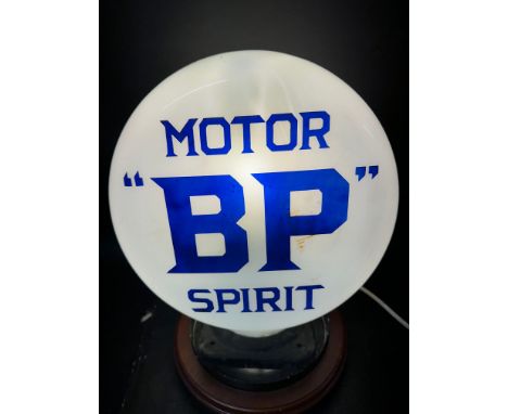 An early "BP" Motor Spirit pill-shaped small glass petrol pump globe, two small nibbles to rim, metal neck surround.