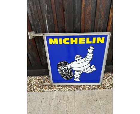 A large Michelin (tyres) 1982 double sided wall mounted enamel advertising sign depicting Mr. Bibendum rolling a tyre, 39 x 3