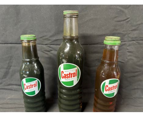 Three Castrol oil bottles with correct lids: a quart and two pints. 