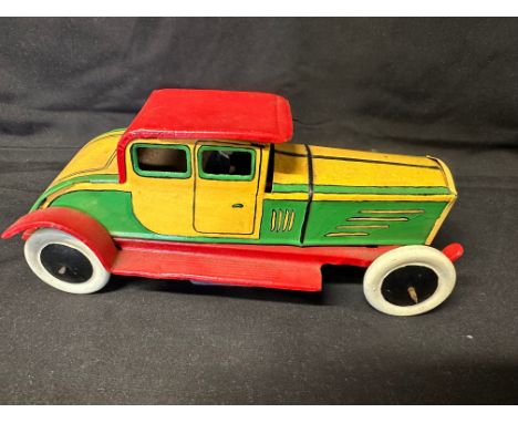 A German tinplate clockwork toy car, appears repainted.