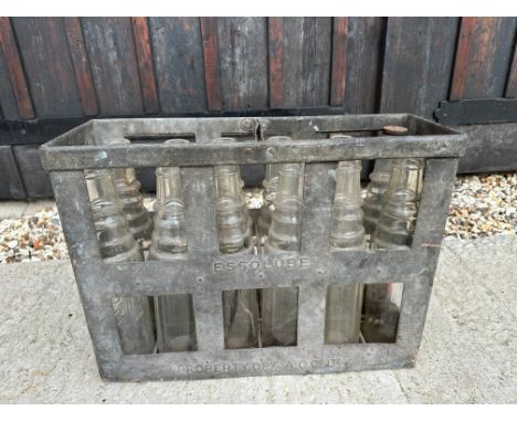 An Essolube 12-bottle crate containing mixed Esso, Essolube and Esso Extra oil bottles.
