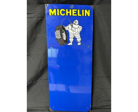 A Michelin enamel tyre pressure chart advertising sign depicting Mr. Bibendum inflating a tyre, 13 1/2 x 33".