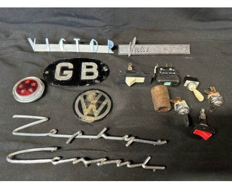 Two Vauxhall Victor car badges, a Ford Consul badge, a Ford Zephyr badge, an oval GB and a VW badge plus a quantity of switch