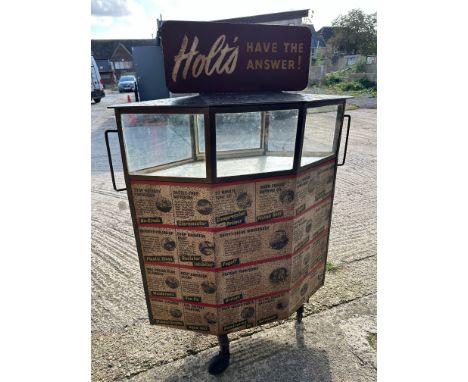 A Holt's steel garage display cabinet with door to rear for storage and a glazed section above with Holt's pediment. Surface 