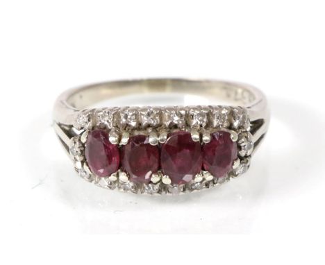 A ruby and diamond ring, four graduated oval cut rubies within a border of eight-cut diamonds, to forked shoulders, total est