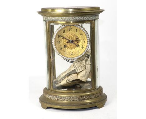 A four glass brass striking oval mantel clock, movement striking on a gong