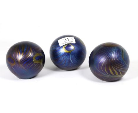 John Ditchfield for Glasform; an iridescent petroleum paperweight decorated with trails and pearl drops, etched to base J. Di