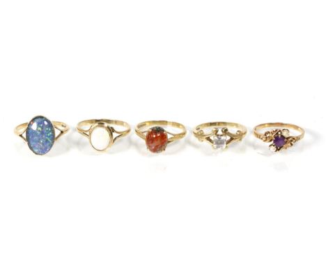 A 9 carat gold opal triplet ring, finger size Q; an opal ring, finger size R; a 9 carat gold agate ring; an amethyst ring; an