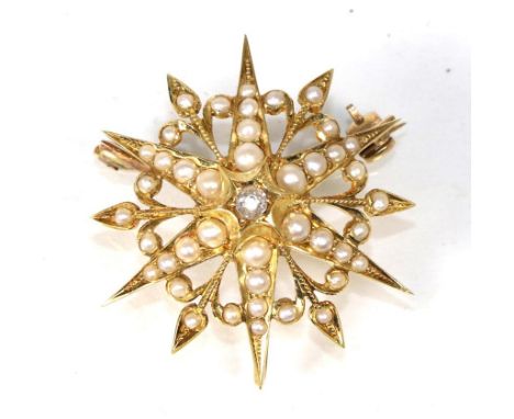 A diamond and seed pearl star brooch/pendant, a central old cut diamond within seed pearl set radial arms, measures 3.5cm in 