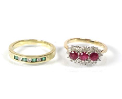 A 9 carat gold ruby and diamond cluster ring, three round cut rubies within a border of round brilliant cut diamonds, total e