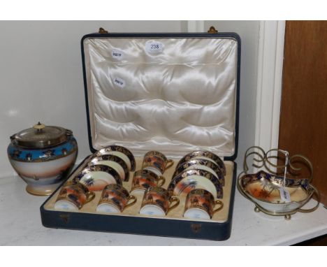 A Noritake coffee service, painted with camels in a desert scene, cased; a matching biscuit barrel; and a dish 