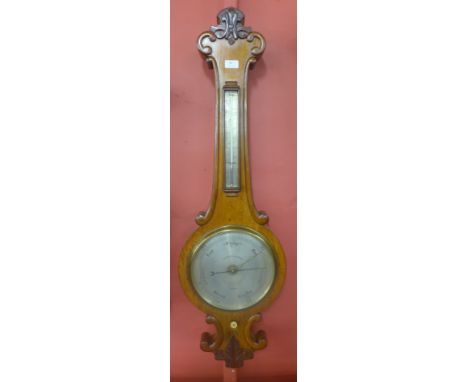 A Victorian oak wheel barometer, the silvered dial signed Negretti &amp; Zambra, 1 Hilton Garden, 59 Cornhill, 122 Regent St 