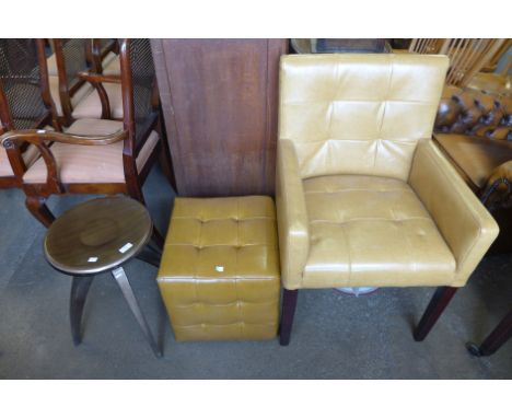 A leather armchair, matching pouffe and a metal stool 
