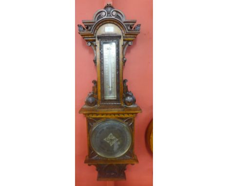 A Victorian carved oak aneroid barometer, the silvered dial signed E. Lennie Optician, Edinburgh 