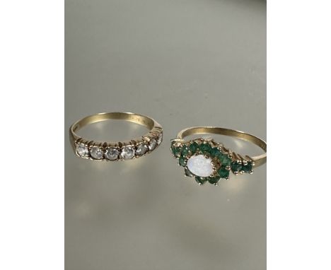 A 9ct gold half eternity style ring set seven clear stones, O, 2g and a 9ct gold water opal and emerald cluster ring set two 