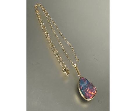 18ct gold mounted pendant set shaped black opal in rub-over setting, (L x 2.5cm x W x 1.5cm) with bar suspension set brillian