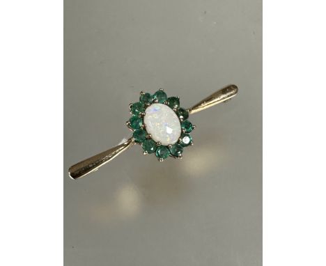 A 9ct gold water opal and emerald cluster set bar brooch, (L x 4cm x W x 1.5cm) 2.6g&nbsp;