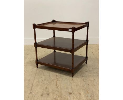 A mahogany three tier side table in the Georgian taste, each tier raised on ring turned supports H66cm, W61cm, D52cm.