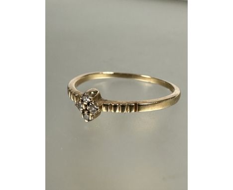 A 1920's European 10ct gold ring set four diamond points in claw setting flanked by engraved shoulders, L. 1.1g